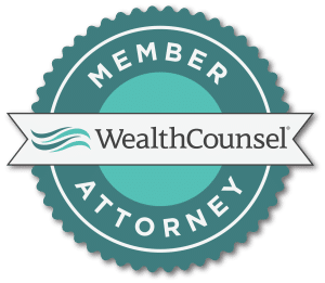 Circular badge identifying a member attorney of Wealth Counsel